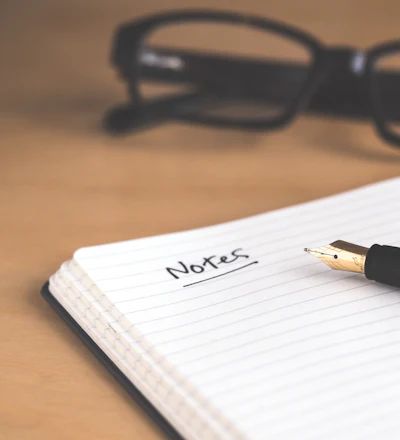 Notebook, fountain pen and reading glasses